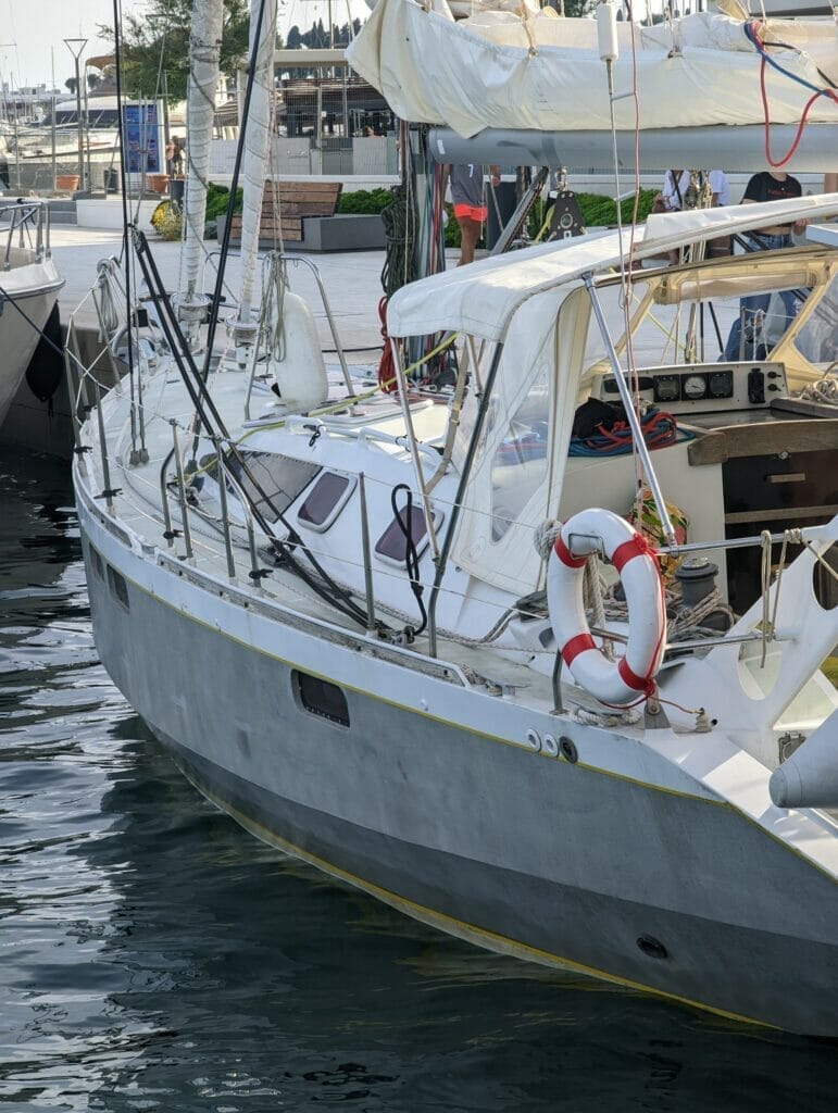 docked aluminum sailing boat with unpainted hull