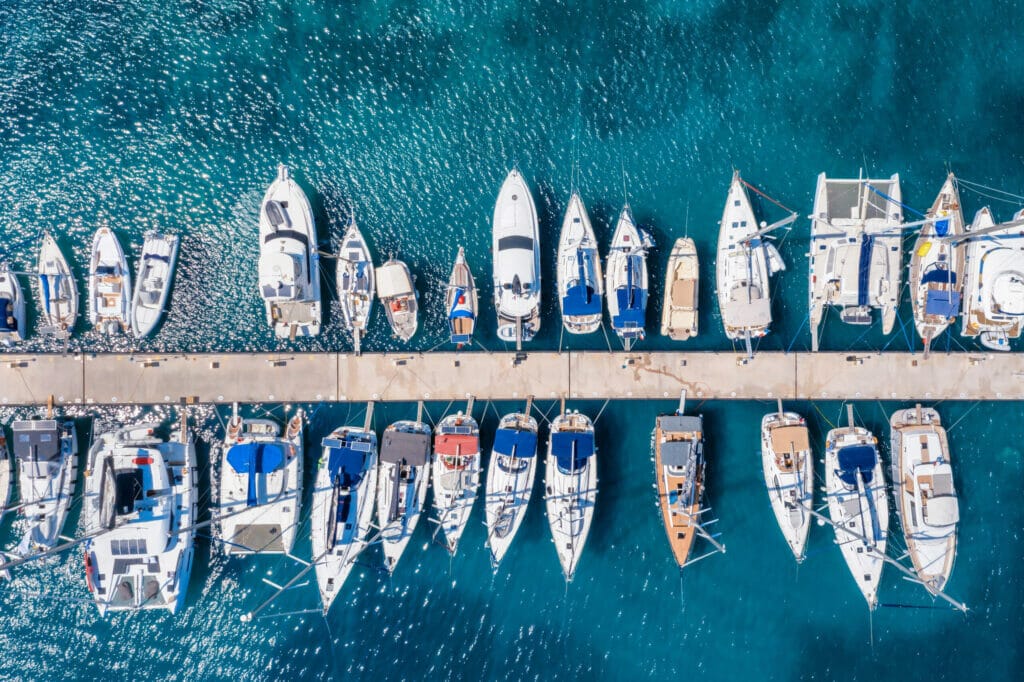 Aerial view of a marina with numerous sailboats and yachts
