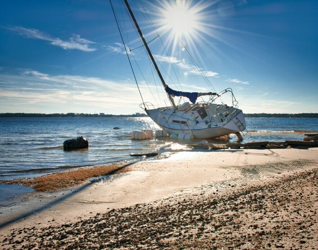 abandoned sailing yacht that is stranded on the beach