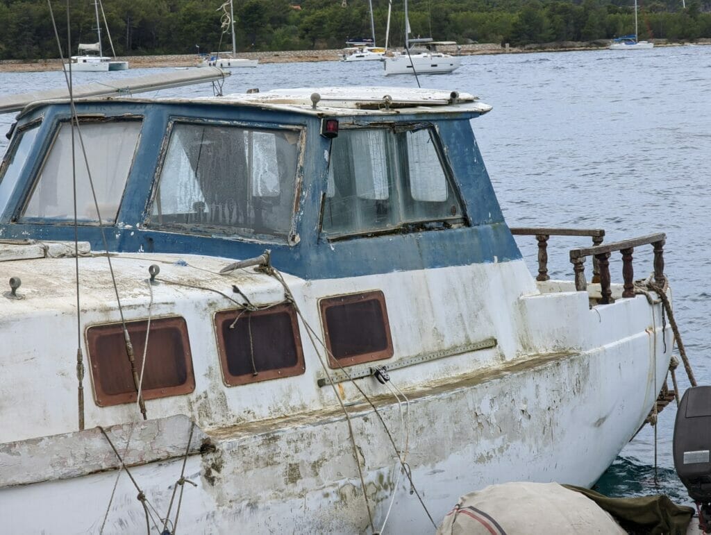 end-of-life fishing boat abandoned in marina