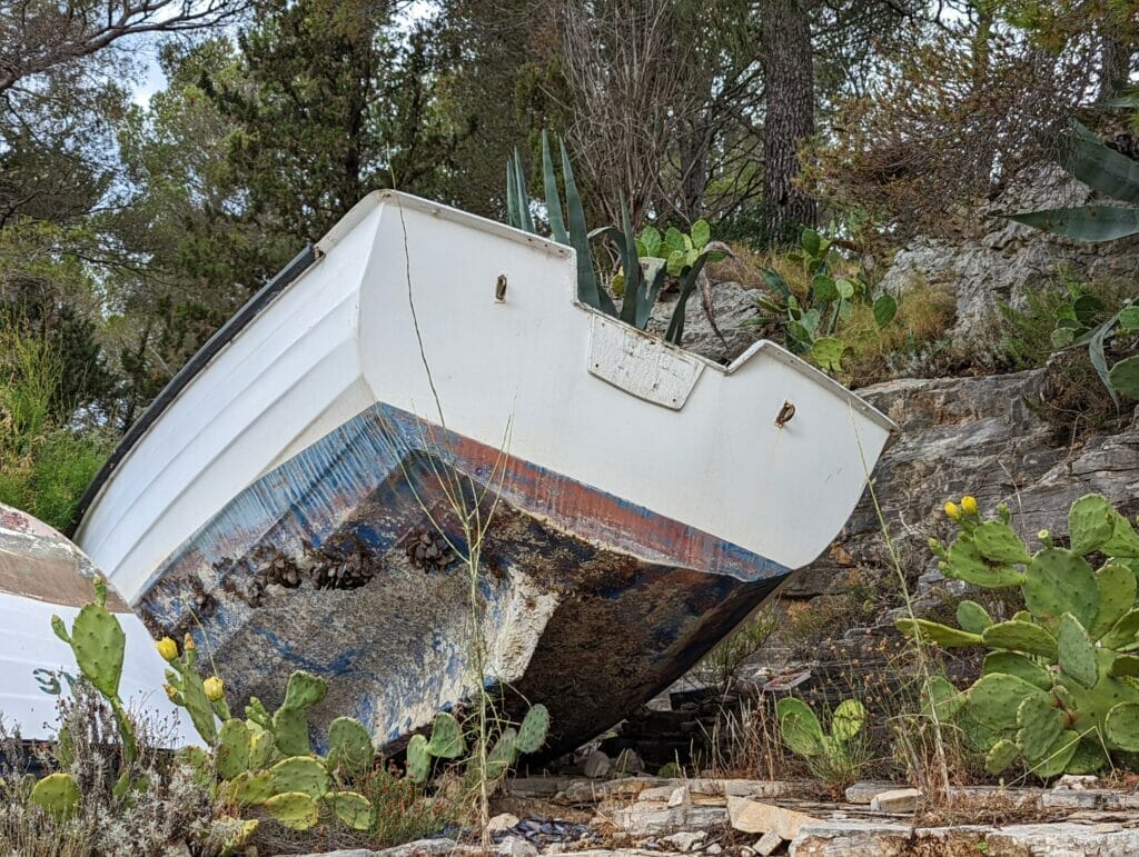 small end-of-life boat dumped in the nature