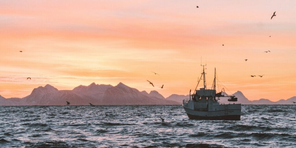 trawler / passagemaker yacht during sunset, in the background mountains.